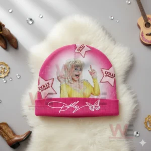 Pink beanie with Dolly Parton image and star decorations placed on a white fluffy background.