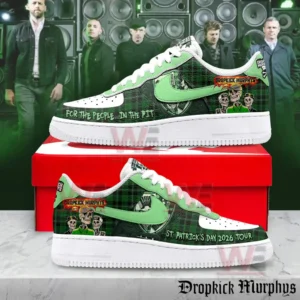 Pair of green plaid themed sneakers with band artwork and tour text displayed on a red shoebox with musicians and speakers in the background!