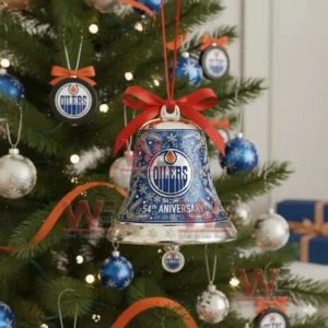 Blue Edmonton Oilers 54th anniversary bell ornament with snowflake designs and a red bow hanging on a decorated Christmas tree!