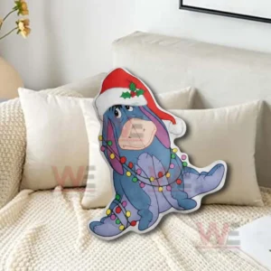 Blue donkey christmas pillow with santa hat and colorful lights sitting on a beige sofa with soft cushions!