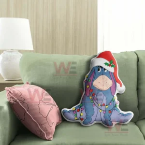 Eeyore Winnie The Pooh Christmas Custom Shaped Pillow 4 Blue donkey holiday pillow with santa hat and light garland placed on a green chair in a bright room!