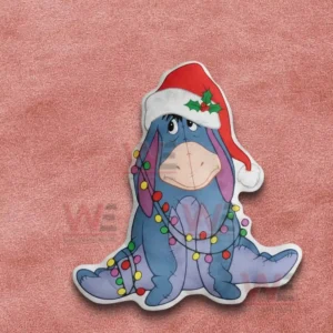 Eeyore Winnie The Pooh Christmas Custom Shaped Pillow 5 Blue donkey christmas pillow with santa hat and colorful lights displayed on a pink fabric surface!