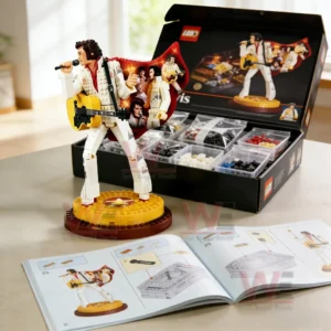 Elvis Presley collector brick figure singing with guitar on a round stage base next to an open kit box and instruction book!