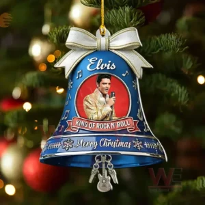 Blue bell ornament with Elvis Presley portrait King of Rock n Roll banner Merry Christmas text musical note accents and a silver bow hanging on a Christmas tree.