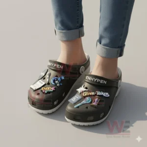 Feet wearing black decorative clogs featuring multiple music themed charms displayed clearly on the upper area!