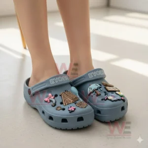 Blue Eeyore themed clogs with multiple cute charms worn indoors!
