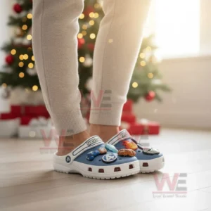 A person wearing blue and white clogs decorated with superhero themed charms in a holiday setting! ``