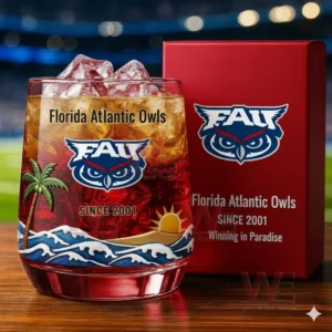 Florida Atlantic Owls branded whiskey glass and red box on a wooden table with a stadium in the background!