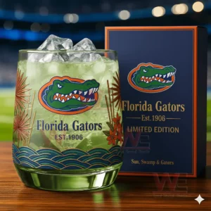 Florida Gators themed glass with green drink ice cubes and decorative design next to a collector box on a wooden table!