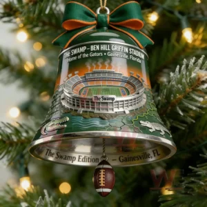 Green bell Christmas ornament featuring The Swamp stadium artwork with a ribbon top hanging on a decorated tree in a festive setting!