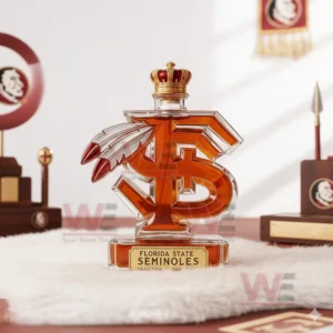 A stylized F S bottle with feather elements placed on a fluffy surface surrounded by memorabilia!