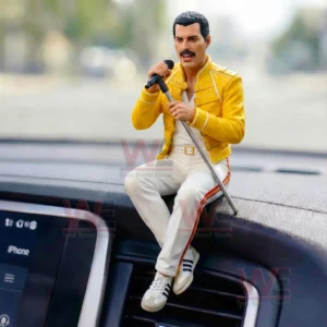 Yellow jacket male singer figurine sitting on a car dashboard holding a microphone stand during daytime!