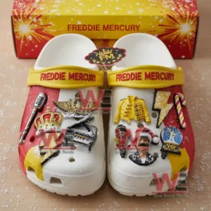 Freddie Mercury themed clogs decorated with musical and holiday charms placed in front of a matching bright box!