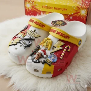 Freddie Mercury Crocs Clogs With Charms 7 Freddie Mercury themed clogs with musical and holiday charms resting on a white rug with a matching box behind!