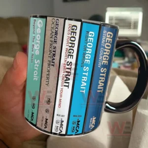 Handheld ceramic mug featuring retro cassette album spines inspired by George Strait music style!