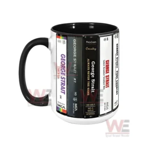Side view of a ceramic mug decorated with George Strait cassette album spine designs!