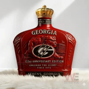 A red Georgia Bulldogs bottle with a gold crown topper resting on a white rug in a bright room!