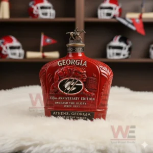 A red Georgia Bulldogs bottle with a horse rider topper placed on a white rug in a team memorabilia room!