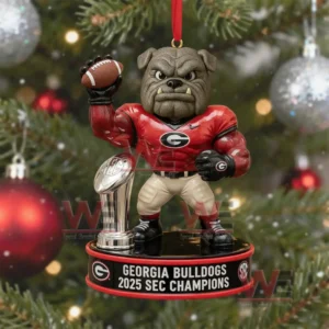A close view of a Georgia Bulldogs mascot ornament holding a football and standing next to a trophy displayed on a Christmas tree with holiday lights and ornaments!