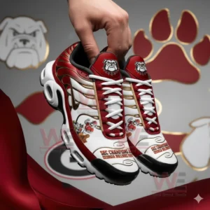 Two red white and gold athletic shoes with Georgia Bulldogs graphics held up against a matching themed background!