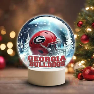 Snow globe style display featuring a Georgia Bulldogs helmet on a white base in a winter scene!