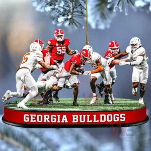 A Georgia Bulldogs running back fighting through defenders on a small football field ornament with the team name on the base!