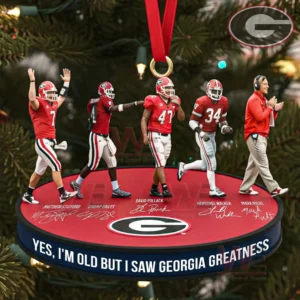 A group of Georgia Bulldogs legends arranged on a red ornament base with signatures and a prideful message in front of a Christmas tree!