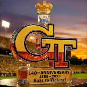 GT shaped Georgia Tech bottle with gold crown cap and anniversary plaque at sunset.