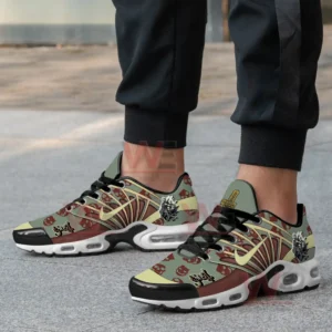 Ghost Band themed green and brown shoes with skull motifs worn by a person on pavement!