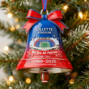 A Christmas bell ornament with Gillette Stadium artwork a red bow and a small football dangling below marking the years nineteen sixty to twenty twenty five!