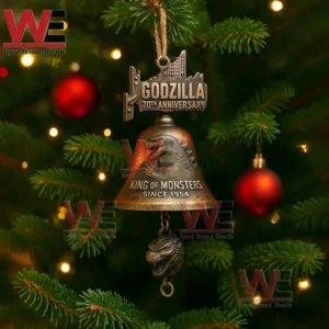 Godzilla themed anniversary bell ornament hanging on a decorated Christmas tree with lights and red baubles!