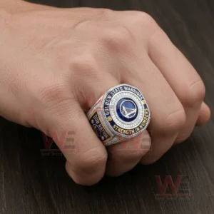 Hand wearing a Golden State Warriors basketball championship ring with blue silver and gold elements!
