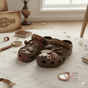 Grandfather Crocs Crocband Clogs With Charms 5 Brown grandfather themed clogs with vintage charms on a white rug with books and accessories.