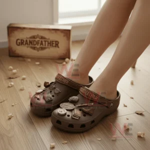 Grandfather Crocs Crocband Clogs With Charms 6 Person wearing brown grandfather themed clogs with vintage charms on a wooden floor.