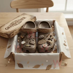 Grandfather Crocs Crocband Clogs With Charms 7 Brown grandfather themed clogs with vintage charms arranged in an open gift box.