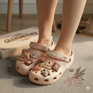 Beige grandmother themed clogs with sweet decorative charms worn on a rug.