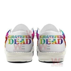 Back view of two rainbow themed canvas shoes featuring large Grateful Dead text across the heel panels on a white background.
