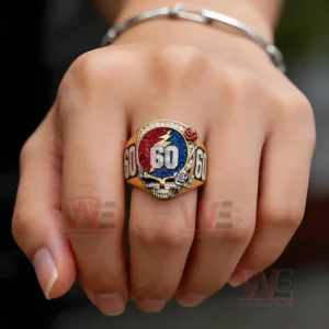 Greatful Dead 60th Anniversary Tribute Skull and Roes Ring 4 Hand wearing a gold skull ring with red and blue stones and number sixty detail!