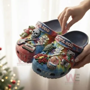 Greatful Dead Christmas Crocs Clogs with Charms 5 Tie dye Grateful Dead Christmas clogs with themed charms being held near holiday decor!