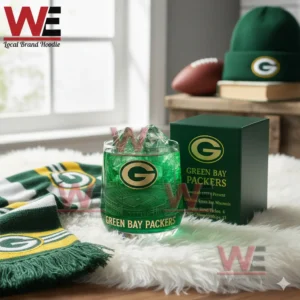 A green Green Bay Packers glass with ice beside a team box surrounded by fan gear!