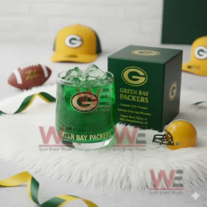 Green Bay Packers 4x Super Bowl Whiskey Glass 6 A green Packers glass with ice beside a team box surrounded by football themed accessories!