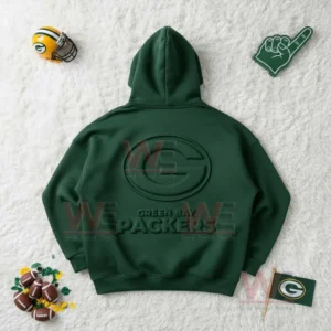 Flat lay of a green Green Bay Packers hoodie with raised logo surrounded by football accessories!