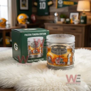 Football stadium themed whiskey glass with amber drink next to a green box in a sports decorated room!