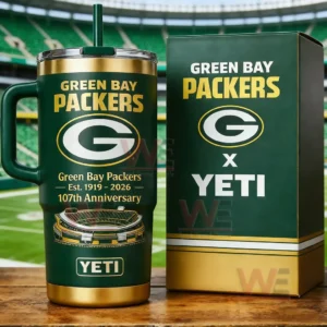 Green Bay Packers Yeti tumbler with handle and straw beside a Green Bay Packers x Yeti box on a wooden surface with stadium seats behind!