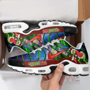 Grinchmas Air Max Plus Sneakers 8 Hand holding a colorful holiday inspired sneaker inside a box highlighting detailed graphics and thick cushioned sole!