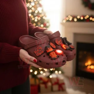Hands holding red heat themed clogs with glowing fire style charms in a Christmas setting!