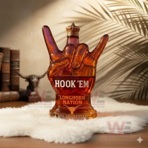 Hook ’em Longhorn Nation 70th Anniversary 1955-2025 Whiskey Bottle 4 Amber Longhorn gesture bottle on white fur with books bull skull and palm shadows in the background!