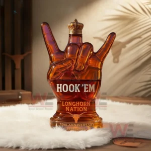 Hook ’em Longhorn Nation 70th Anniversary 1955-2025 Whiskey Bottle 5 Amber Longhorn hand shaped bottle on white fur with warm lighting and wall shadows!