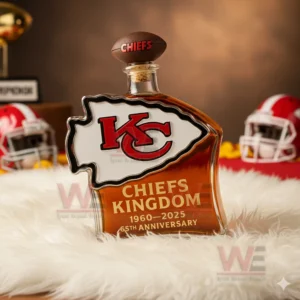 Arrow shaped Chiefs anniversary bottle on white fur with red helmets and football props around it!