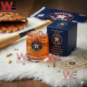 A Houston Astros sixtieth anniversary glass with orange ice beside a blue team box surrounded by baseball items!